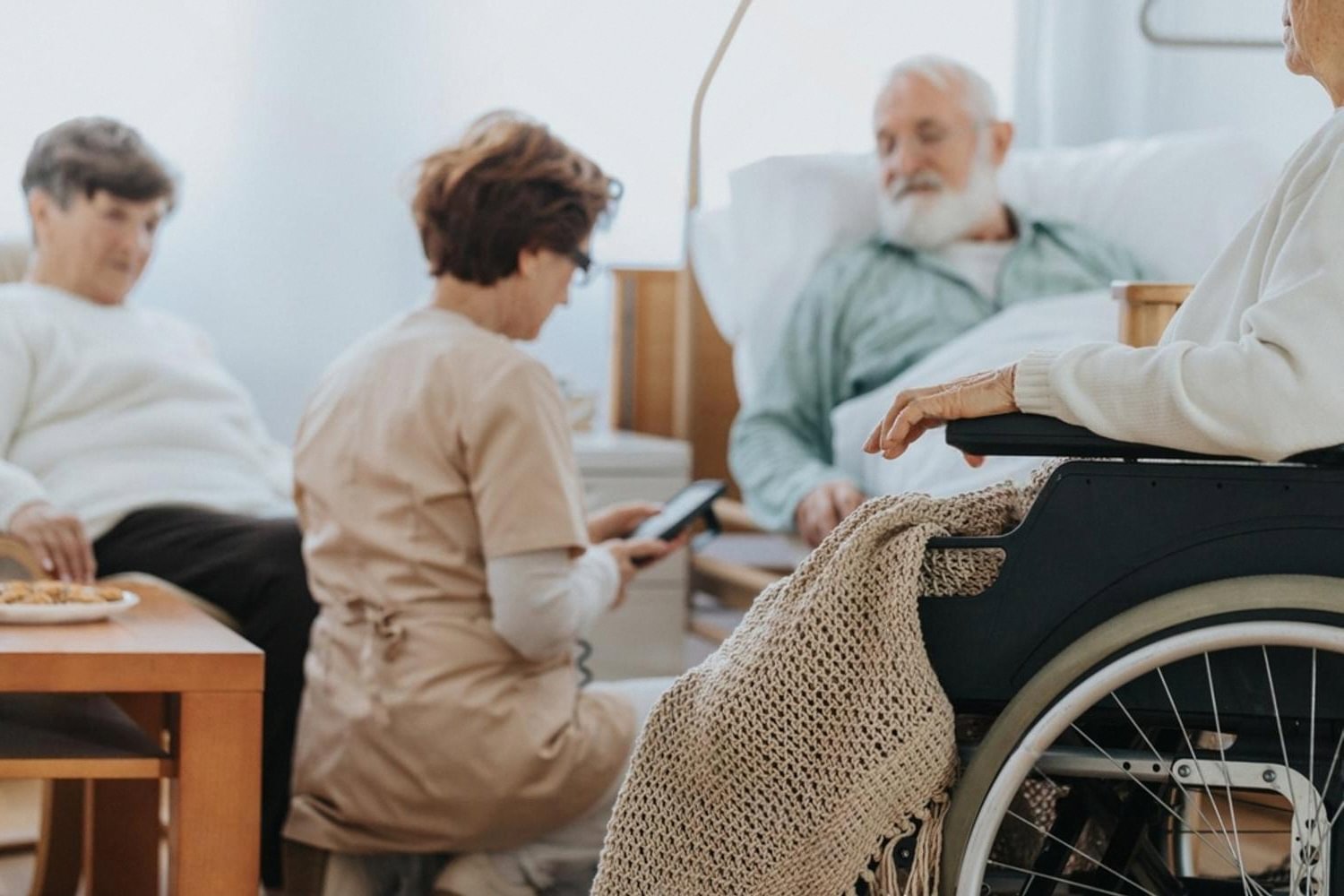 Nurse attending to elderly patients in a UAE inpatient ward, one recovering from a pancreatic disorder